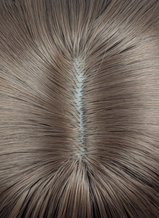 This natural brown colour wig is simple and easy to wear. Its rich brown shades come to life with golden-copper undertones. A sleek long bob (lob) that curls just under at the ends. With a light sleek fringe.