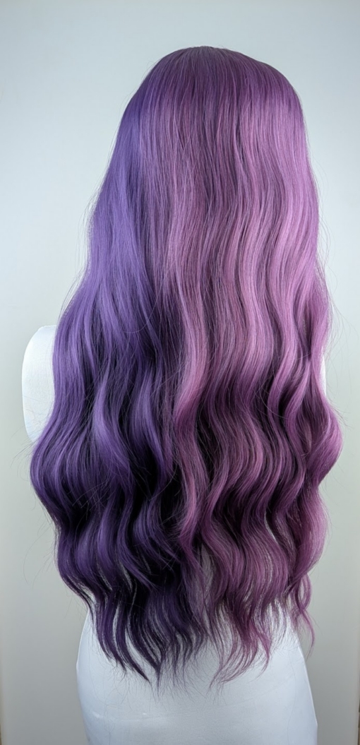Verbena - Lush Wigs UK This two tone split colour wig has one half violet and on the other side a muted purple. The sleek blunt fringe carries the colours seamlessly. Styled into loose barrel curls with plenty of volume.