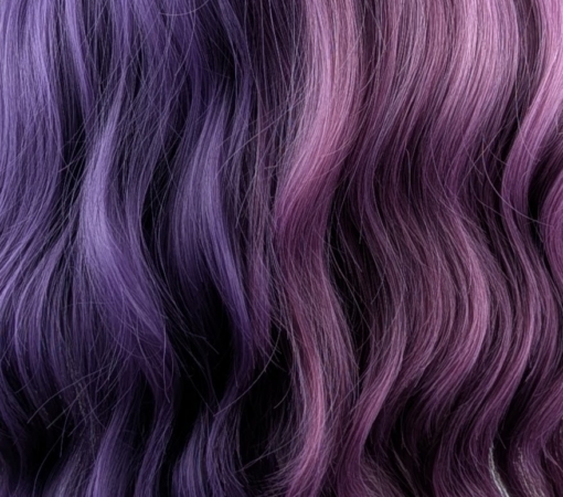 Verbena - Lush Wigs UK This two tone split colour wig has one half violet and on the other side a muted purple. The sleek blunt fringe carries the colours seamlessly. Styled into loose barrel curls with plenty of volume.