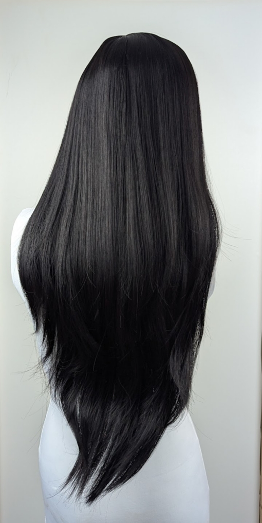 Winter - Lush Wigs UK Winter is a natural warm black colour from roots to tips. A barely there wave running through the lengths. With invisible layers cut in for movement and shape. A blunt sleek fringe completes the look.