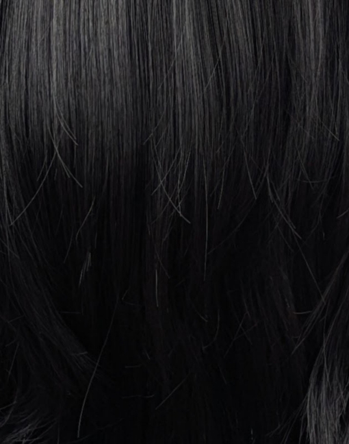 Winter - Lush Wigs UK Winter is a natural warm black colour from roots to tips. A barely there wave running through the lengths. With invisible layers cut in for movement and shape. A blunt sleek fringe completes the look.