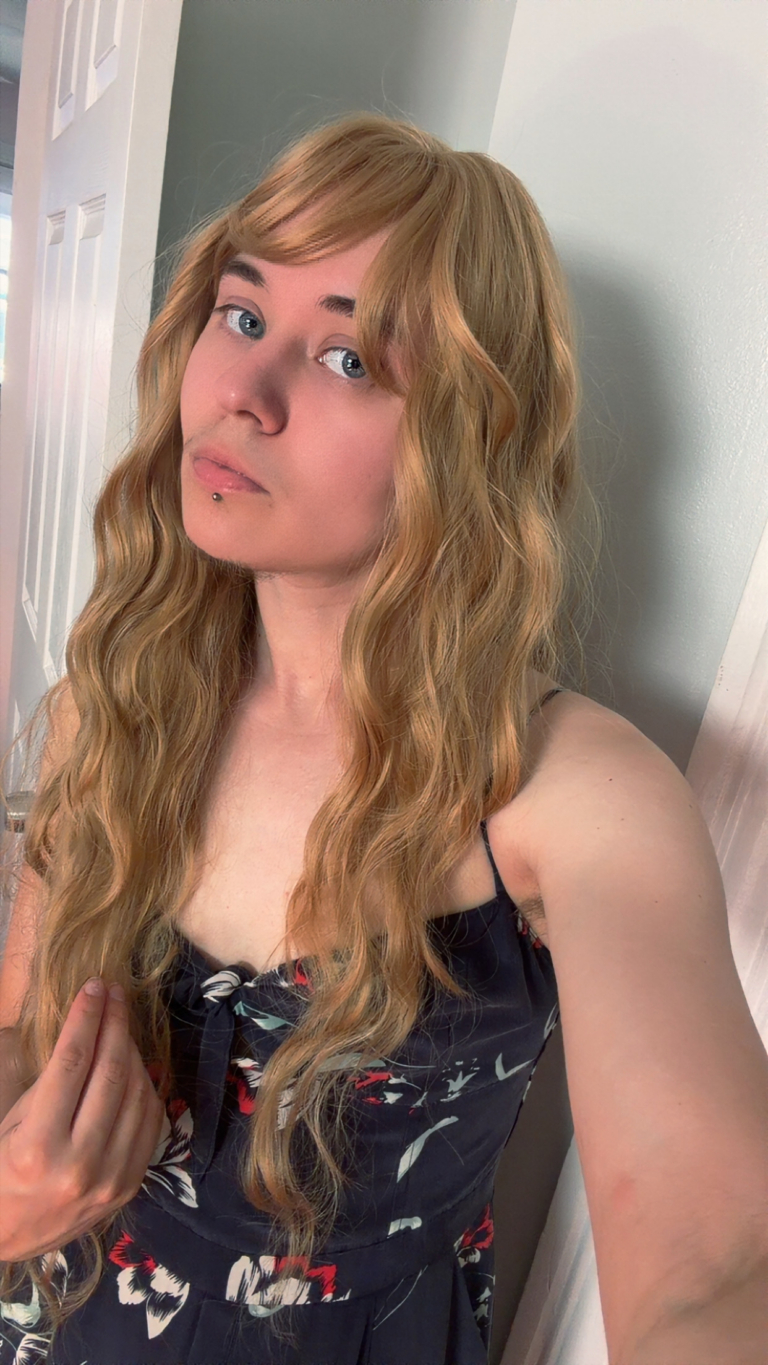 Aurelia - Lush Wigs UK This natural wig comes in a mix of caramel blonde from roots to tips. A Voluminous curly style, cut into face framing layers at the front. With a sleek blunt fringe that finishes the look.