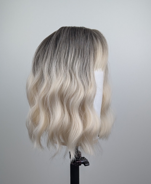 Outlet #149 - Lush Wigs UK A wig with brown shadowed roots that grow into this platinum blonde icy hue. Styled into a bob with loose waves. The fringe is sleek and blunt.
