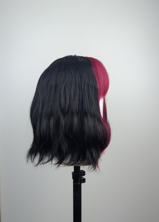 Outlet #236 - Lush Wigs UK This wavy bob comes to life with a face framing slice of bright purple colour. Thats carried into the sleek fringe and adds a peek-a-boo at the sides. A soft black colour from roots to tips.