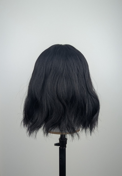 Outlet #236 - Lush Wigs UK This wavy bob comes to life with a face framing slice of bright purple colour. Thats carried into the sleek fringe and adds a peek-a-boo at the sides. A soft black colour from roots to tips.