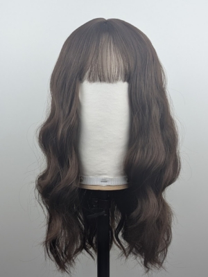 A natural brown chestnut shade from roots to tips with textured, tousled, loose waves. With a sleek blunt fringe.