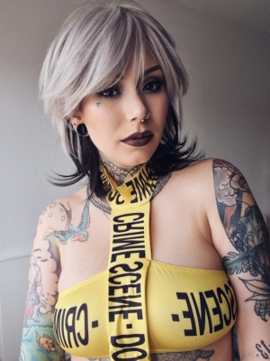 Liquorice - Lush Wigs UK This shaggy short layered sleek cut has body at the crown with a full fringe in a natural grey tone. At the back of the head a layer in a dark brown tine with subtle flick to the ends.